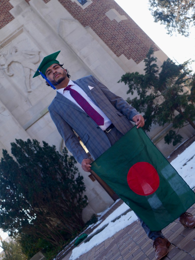 Graduate holding Bangladesh flag in winter setting