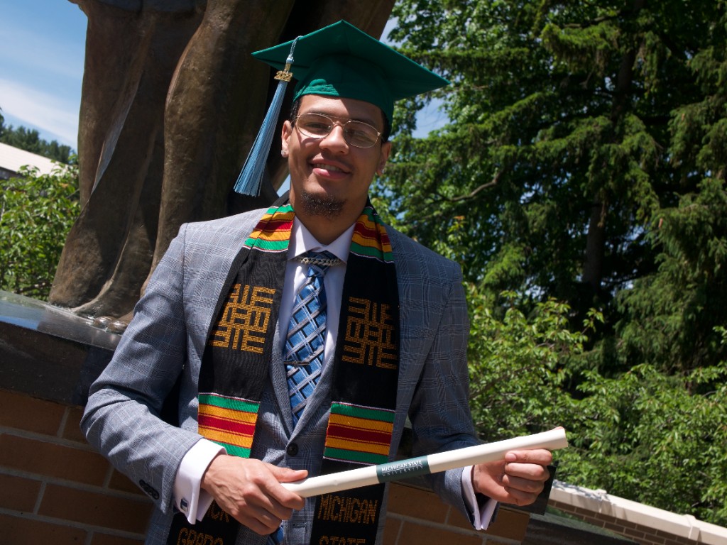 Graduate seated portrait with diploma and stole